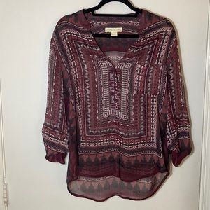 Burgundy geometric patterned sheer blouse.
